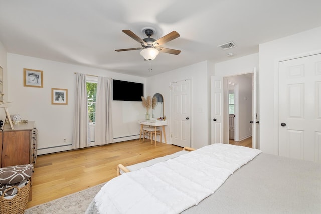 11 Dean Ct, Rutherford, NJ 07070 - bedroom with two closets, light wood finished floors, a baseboard radiator, and ceiling fan