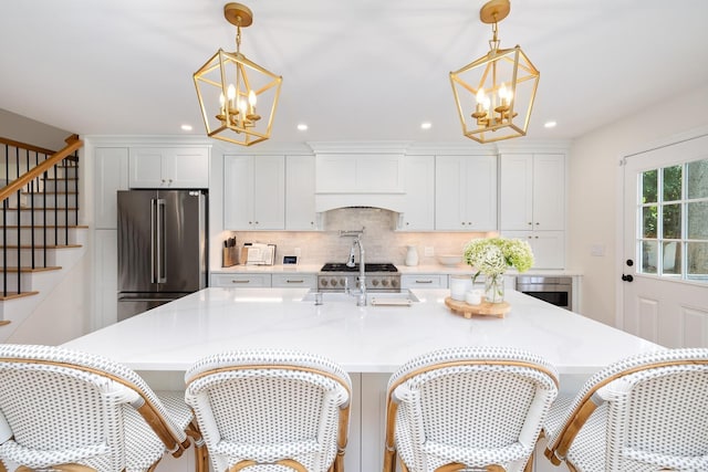 11 Dean Ct, Rutherford, NJ 07070 - kitchen featuring high end refrigerator, a chandelier, custom exhaust hood, a large island with sink, and recessed lighting