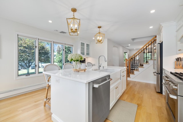 11 Dean Ct, Rutherford, NJ 07070 - kitchen featuring appliances with stainless steel finishes, a chandelier, light wood finished floors, white cabinetry, and recessed lighting