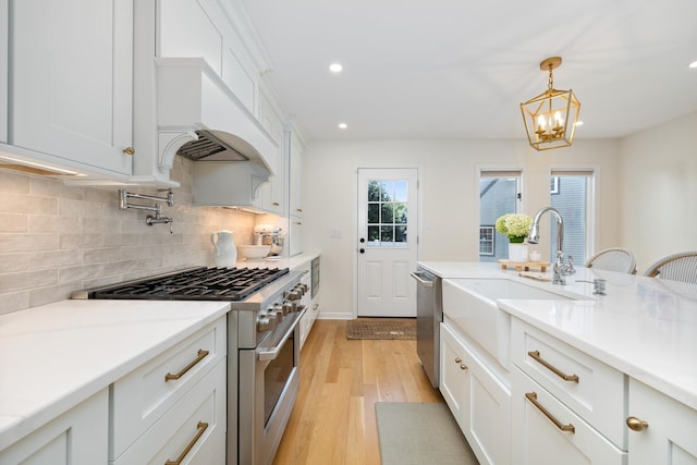 11 Dean Ct, Rutherford, NJ 07070 - kitchen featuring stainless steel appliances, light wood-type flooring, decorative backsplash, recessed lighting, and white cabinets