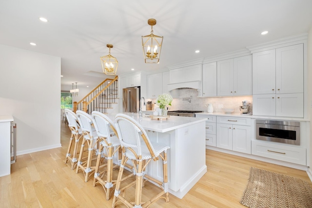 11 Dean Ct, Rutherford, NJ 07070 - kitchen with a chandelier, light countertops, recessed lighting, tasteful backsplash, and light wood-type flooring