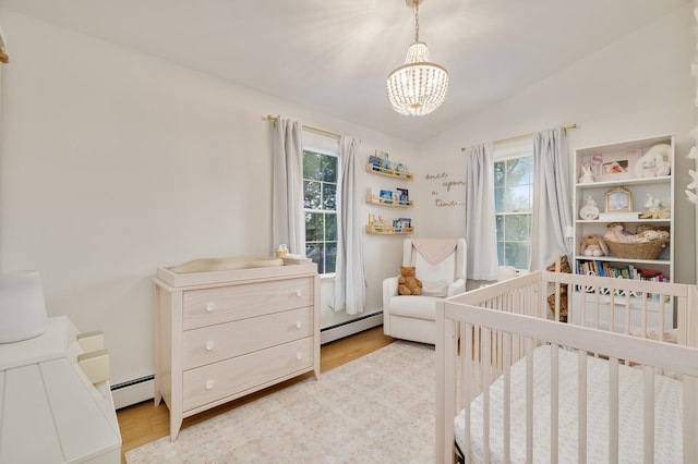 11 Dean Ct, Rutherford, NJ 07070 - bedroom with a baseboard heating unit, a chandelier, multiple windows, a crib, and vaulted ceiling