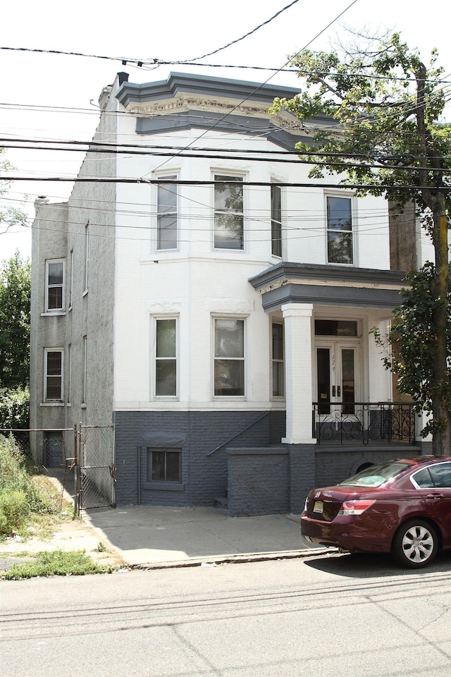 179 Beacon Ave, Jersey City, NJ 07306 - view of front of house with stucco siding, brick siding, and a gate