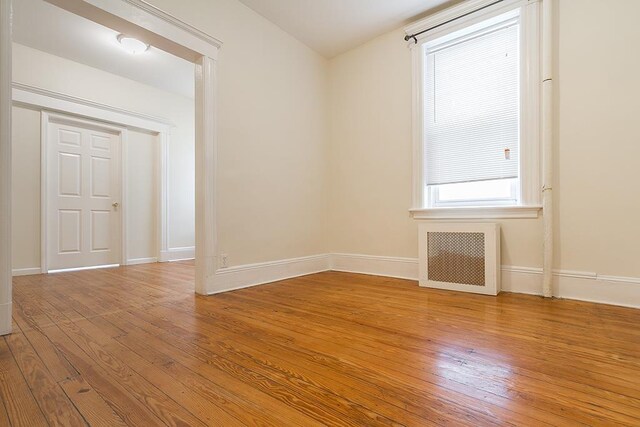 179 Beacon Ave, Jersey City, NJ 07306 - spare room with radiator heating unit, light wood-type flooring, and baseboards