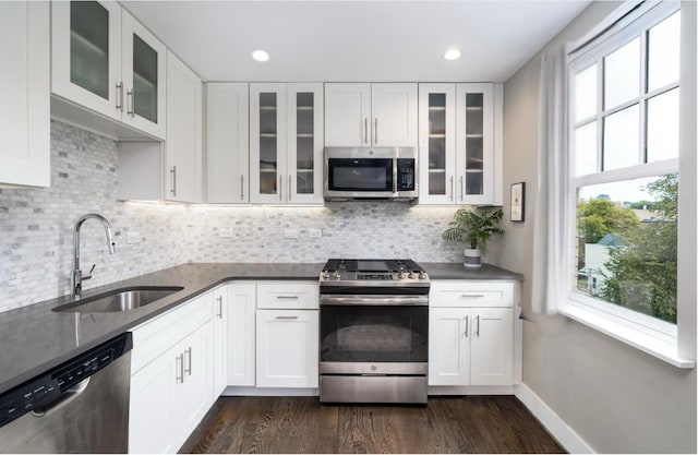 126 Delaware Ave Unit 12, Jersey City, NJ 07306 - kitchen featuring appliances with stainless steel finishes, healthy amount of natural light, dark wood-style flooring, white cabinets, and recessed lighting