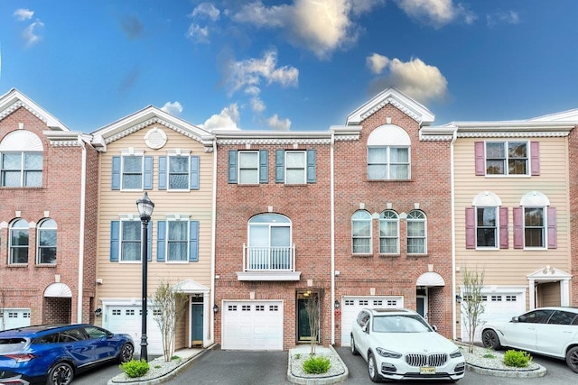 235 Price Ct, West New York, NJ 07093 - townhome / multi-family property with an attached garage, driveway, and brick siding