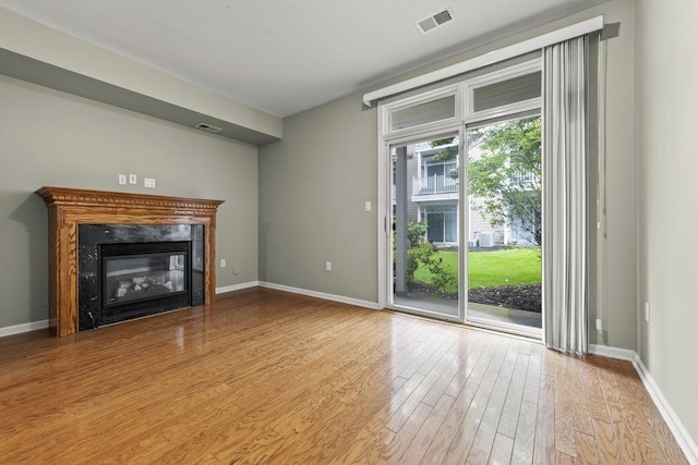 235 Price Ct, West New York, NJ 07093 - unfurnished living room featuring light wood finished floors and a fireplace