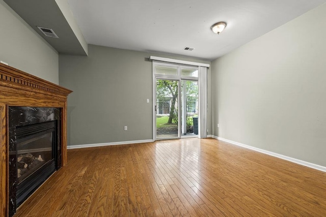 235 Price Ct, West New York, NJ 07093 - unfurnished living room with wood finished floors and a premium fireplace