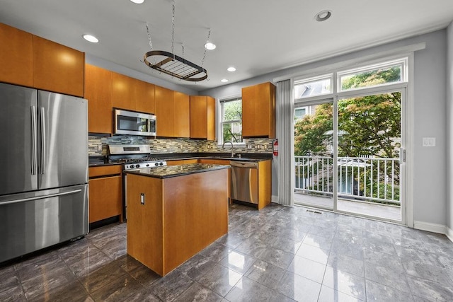 235 Price Ct, West New York, NJ 07093 - kitchen featuring stainless steel appliances, dark countertops, decorative backsplash, brown cabinetry, and recessed lighting