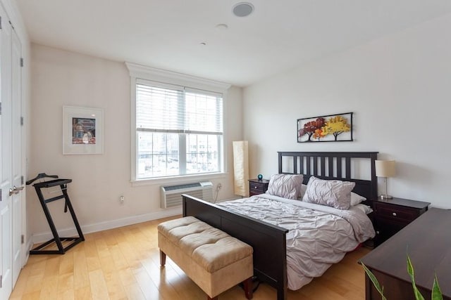 102 Tidewater St Unit 2B, Jersey City, NJ 07302 - bedroom featuring a wall mounted air conditioner, light wood-style floors, and baseboards