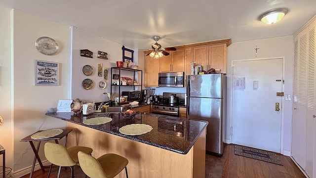 380 Mountain Rd Unit 210, Union City, NJ 07087 - kitchen featuring a peninsula, dark wood-style flooring, appliances with stainless steel finishes, and ceiling fan