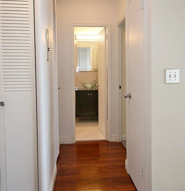 380 Mountain Rd Unit 210, Union City, NJ 07087 - hallway with a sink, baseboards, and dark wood-style flooring