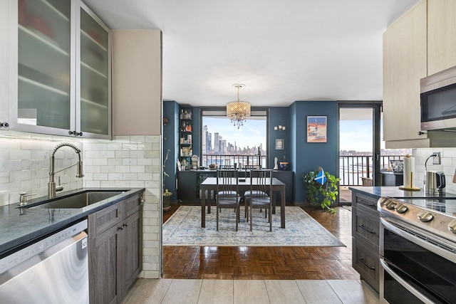 kitchen featuring gray cabinets, stainless steel appliances, and tasteful backsplash