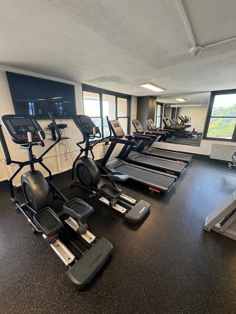 workout area featuring a textured ceiling