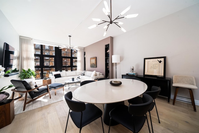 dining space with an inviting chandelier and light wood-type flooring