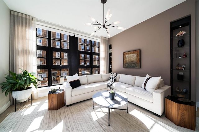 living room with baseboards and a chandelier