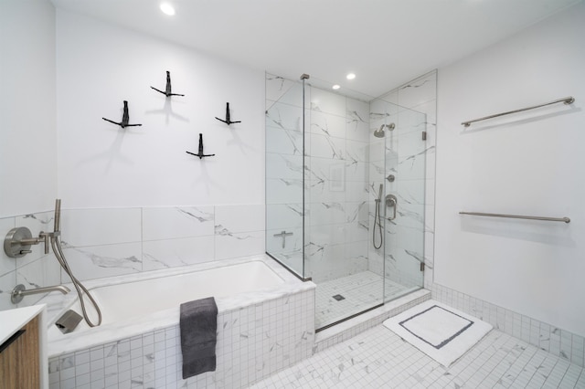bathroom with recessed lighting, a marble finish shower, and a garden tub