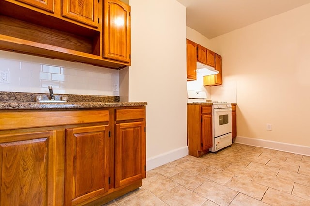 kitchen featuring white gas range oven, tasteful backsplash, baseboards, open shelves, and under cabinet range hood