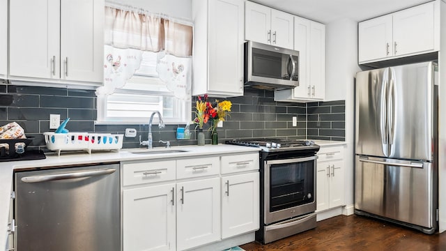 2212 Grand Ave, North Bergen, NJ 07047 - kitchen featuring stainless steel appliances, a sink, light countertops, and white cabinetry