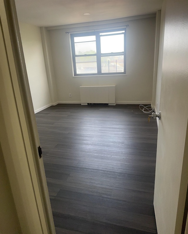 1225 Kennedy Blvd Unit 4J, Bayonne, NJ 07002 - unfurnished room with radiator and dark wood-style floors