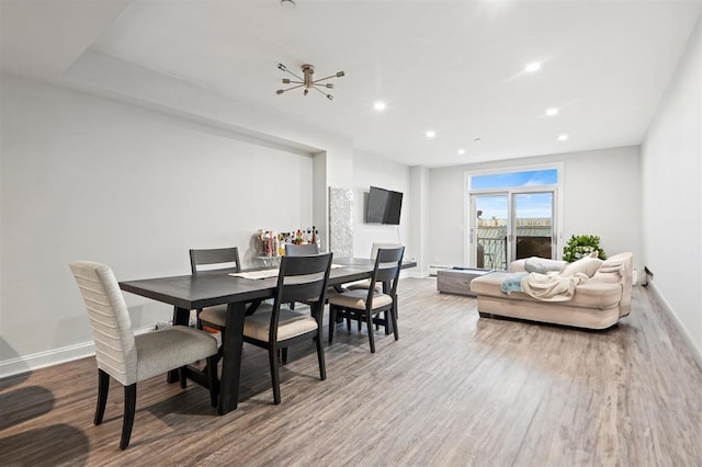 dining room featuring recessed lighting, baseboards, and wood finished floors
