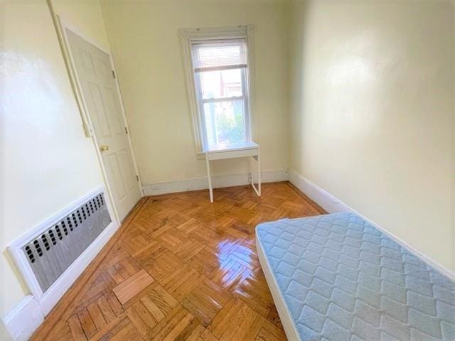 unfurnished bedroom with light parquet floors