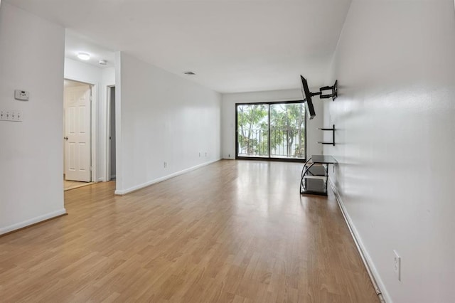 603 55th St Unit 210, West New York, NJ 07093 - unfurnished living room featuring baseboards and light wood-style flooring
