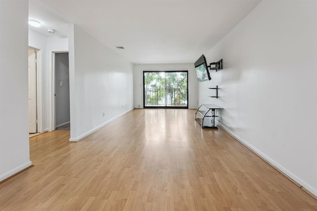 603 55th St Unit 210, West New York, NJ 07093 - unfurnished living room featuring light wood-style flooring and baseboards