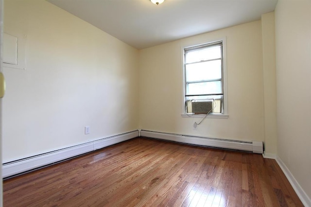 330 2nd St, Jersey City, NJ 07302 - spare room with a baseboard radiator, cooling unit, wood-type flooring, and baseboards