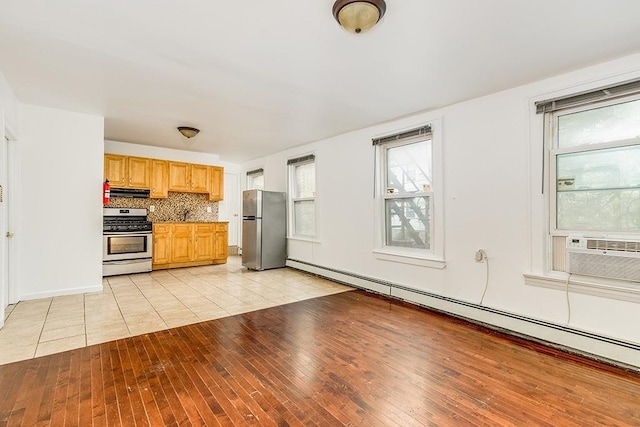 330 2nd St, Jersey City, NJ 07302 - kitchen with stainless steel appliances, healthy amount of natural light, light wood finished floors, and backsplash