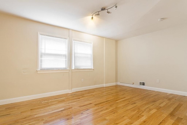 330 2nd St, Jersey City, NJ 07302 - spare room featuring light wood-style flooring, rail lighting, and baseboards
