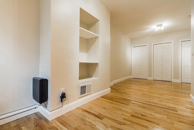 330 2nd St, Jersey City, NJ 07302 - mudroom with baseboards, built in features, wood finished floors, and baseboard heating