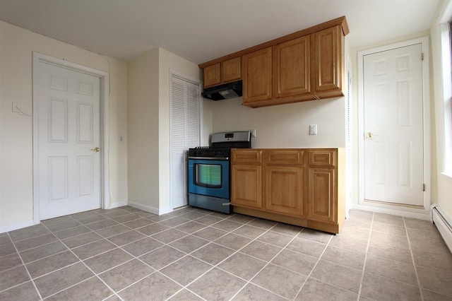330 2nd St, Jersey City, NJ 07302 - kitchen with stainless steel gas range, under cabinet range hood, light tile patterned floors, and brown cabinets