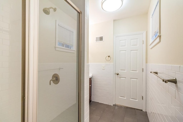 330 2nd St, Jersey City, NJ 07302 - full bath featuring tile walls, a shower stall, and a wainscoted wall