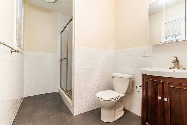 330 2nd St, Jersey City, NJ 07302 - bathroom featuring tile walls, a shower stall, wainscoting, tile patterned floors, and toilet