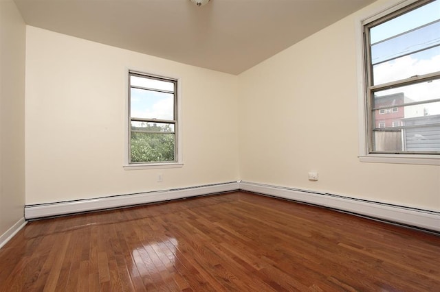 330 2nd St, Jersey City, NJ 07302 - empty room featuring wood-type flooring, a baseboard heating unit, and baseboards