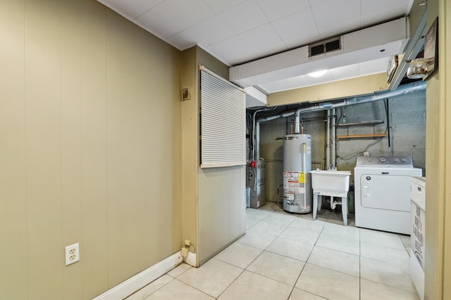 12 Egan Ct, Bayonne, NJ 07002 - washroom with washer / dryer, gas water heater, and light tile patterned flooring