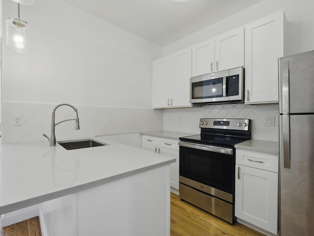 522 Jefferson St Unit 3, Hoboken, NJ 07030 - kitchen with stainless steel appliances, a sink, decorative backsplash, and light countertops