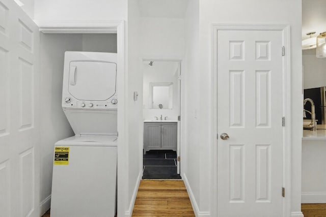 522 Jefferson St Unit 3, Hoboken, NJ 07030 - washroom with stacked washer / drying machine, wood finished floors, and baseboards