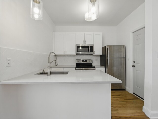 522 Jefferson St Unit 3, Hoboken, NJ 07030 - kitchen featuring appliances with stainless steel finishes, a sink, tasteful backsplash, and white cabinets