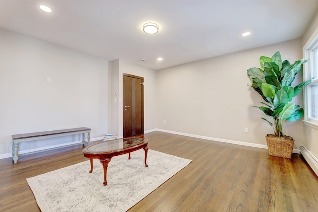 sitting room featuring hardwood / wood-style flooring and baseboard heating