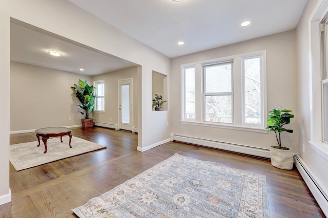 entrance foyer featuring dark wood-type flooring and a baseboard radiator