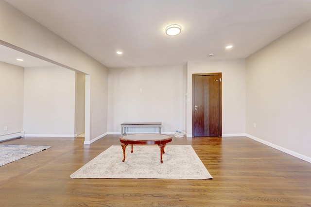 living area featuring hardwood / wood-style flooring and a baseboard radiator