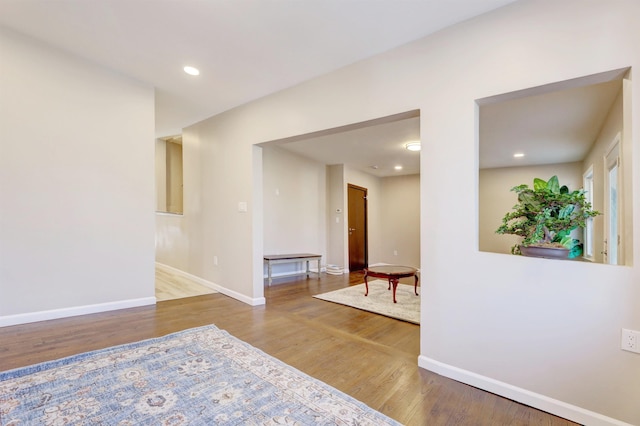 corridor with hardwood / wood-style floors