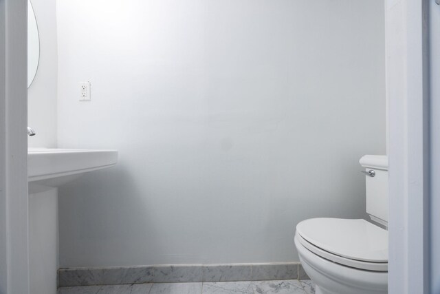 186 Wayne St Unit 423D, Jersey City, NJ 07302 - half bathroom featuring marble look tile flooring and toilet