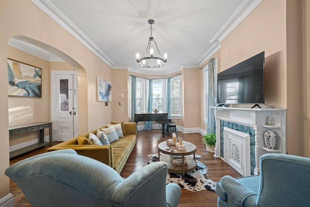 living room featuring an inviting chandelier, dark hardwood / wood-style floors, and ornamental molding