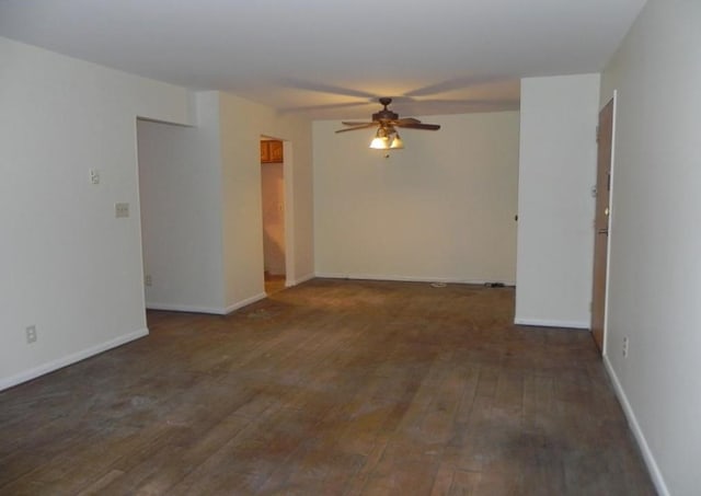 empty room with a ceiling fan, wood-type flooring, and baseboards