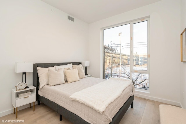 425 3rd St Unit 318, Jersey City, NJ 07302 - bedroom featuring multiple windows, light wood-type flooring, and baseboards