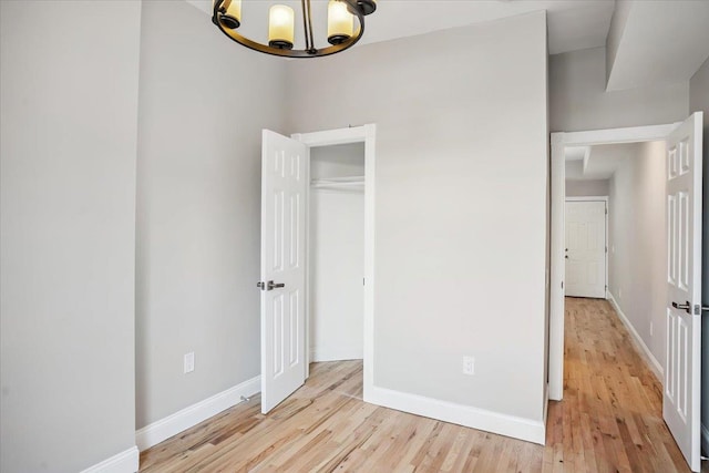 159 14th St Unit 4R, Hoboken, NJ 07030 - unfurnished bedroom with a chandelier, light wood-style floors, and a closet