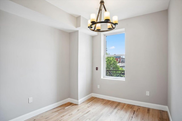 159 14th St Unit 4R, Hoboken, NJ 07030 - spare room featuring a chandelier and light wood-type flooring